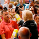 U.S. President Donald Trump hands out bags of rice.